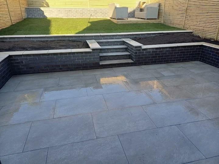 Garden landscaping project underway with porcelain paving, sleeper-edged lawn and fencing being planned for a family garden