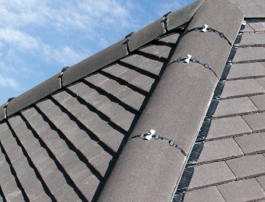 Completed grey slate roof with mortared ridge tiles on a UK home, full roof replacement by Kestrel Property Solutions
